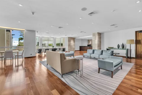 a spacious bedroom with a bed and wooden floor