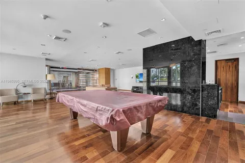a living room with furniture a rug and a wall painting