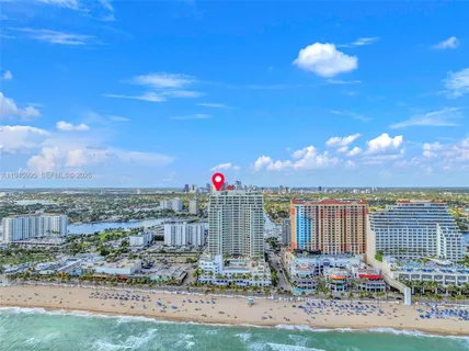a view of a patio with a table and chairs under an umbrella