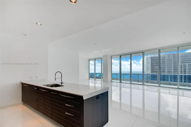 a bathroom with a tub a sink and a large mirror