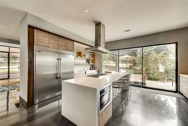 a kitchen with stainless steel appliances a sink a stove and a refrigerator