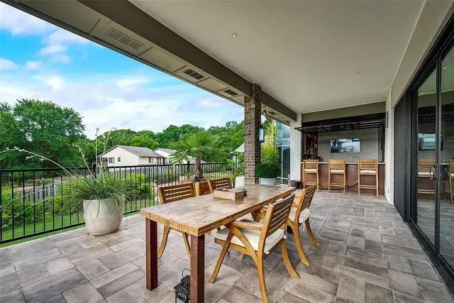 a view of a patio with a table chairs and a backyard