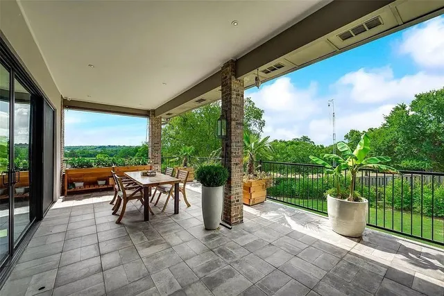 a view of a porch with furniture and garden