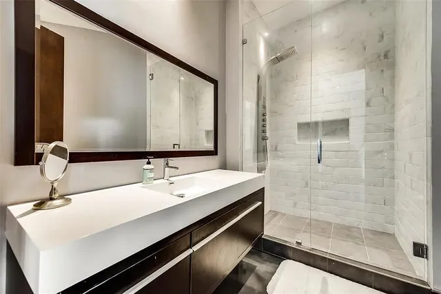 a bathroom with a double vanity sink and mirror