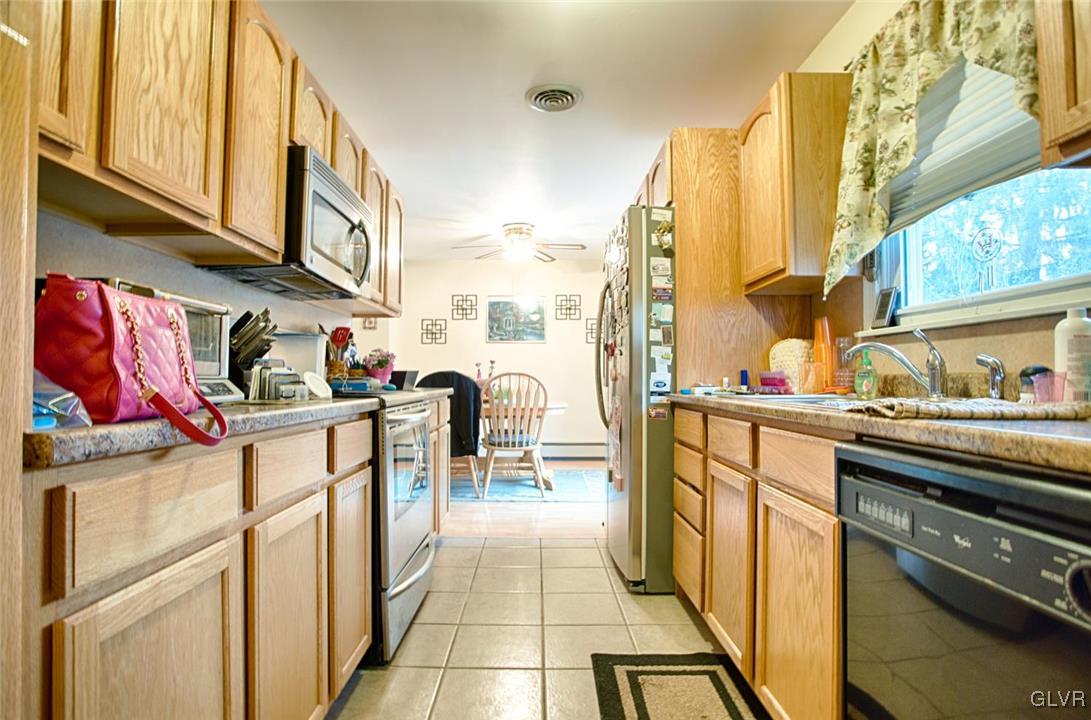 561 Clearfield Road Nazareth, PA 18064 - Photo 4 of 23 a kitchen with stainless steel appliances granite countertop a refrigerator and a stove top oven