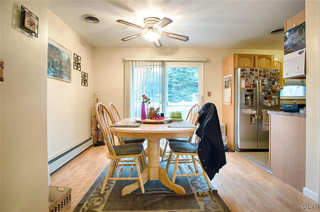 561 Clearfield Road Nazareth, PA 18064 - Photo 6 of 23 a dining room with furniture a chandelier and wooden floor