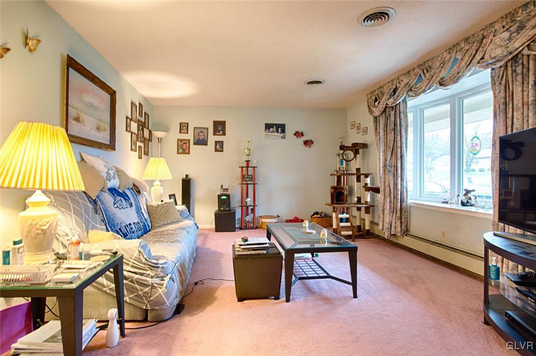 561 Clearfield Road Nazareth, PA 18064 - Photo 7 of 23 a living room with furniture a flat screen tv and a window