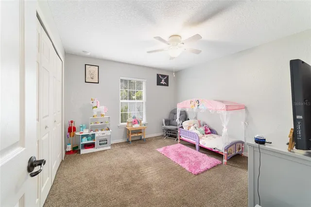 a bedroom with furniture and a flat screen tv