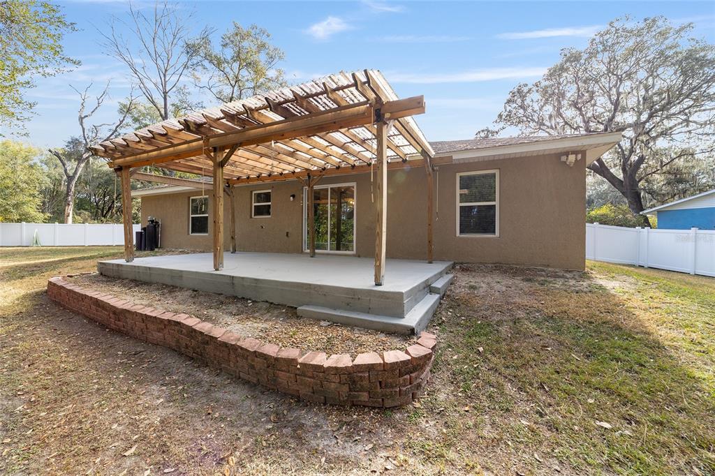 38 Cedar Tree Terrace Ocala, FL 34472 - Photo 13 of 18 a view of a house with a small yard and wooden fence