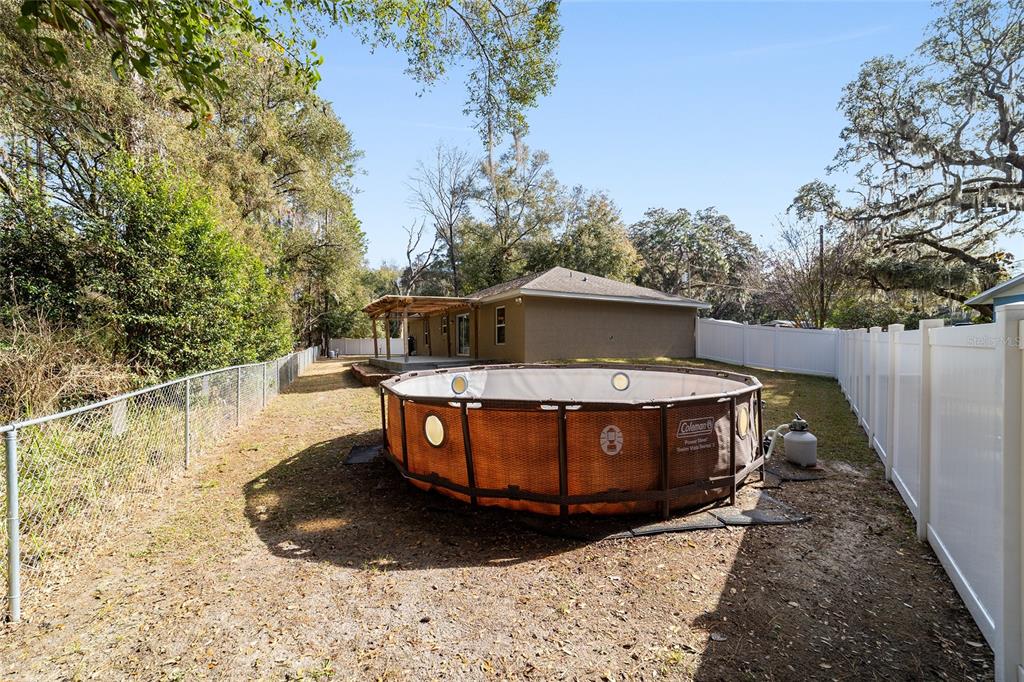 38 Cedar Tree Terrace Ocala, FL 34472 - Photo 14 of 18 a view of a swimming pool with a yard
