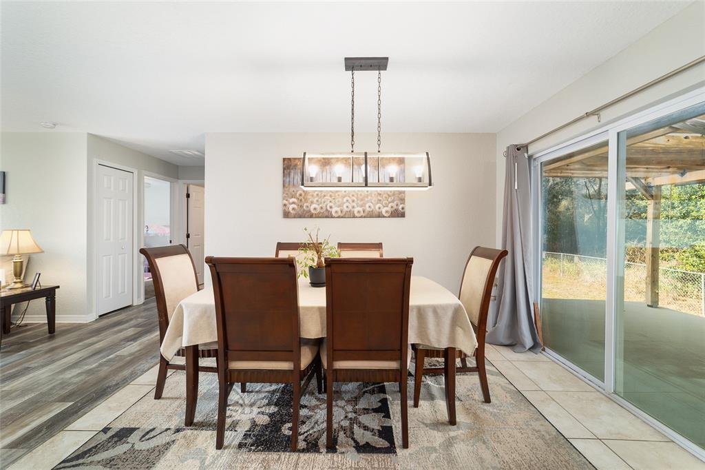 38 Cedar Tree Terrace Ocala, FL 34472 - Photo 5 of 18 a view of a dining room with furniture window and wooden floor