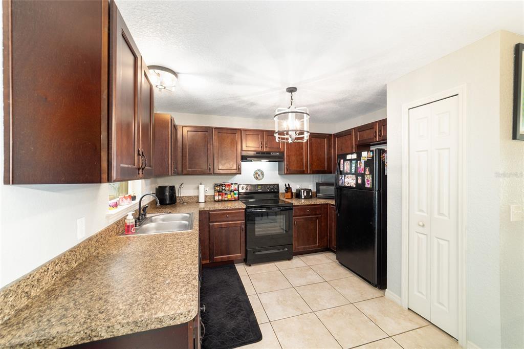 38 Cedar Tree Terrace Ocala, FL 34472 - Photo 6 of 18 a kitchen with stainless steel appliances granite countertop a sink stove and refrigerator