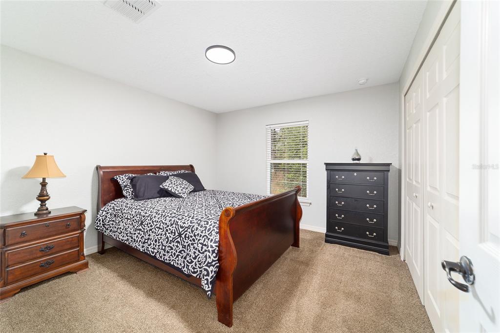 38 Cedar Tree Terrace Ocala, FL 34472 - Photo 10 of 18 a bedroom with a bed and a cabinets