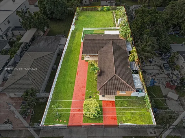 an aerial view of a tennis ground with large trees