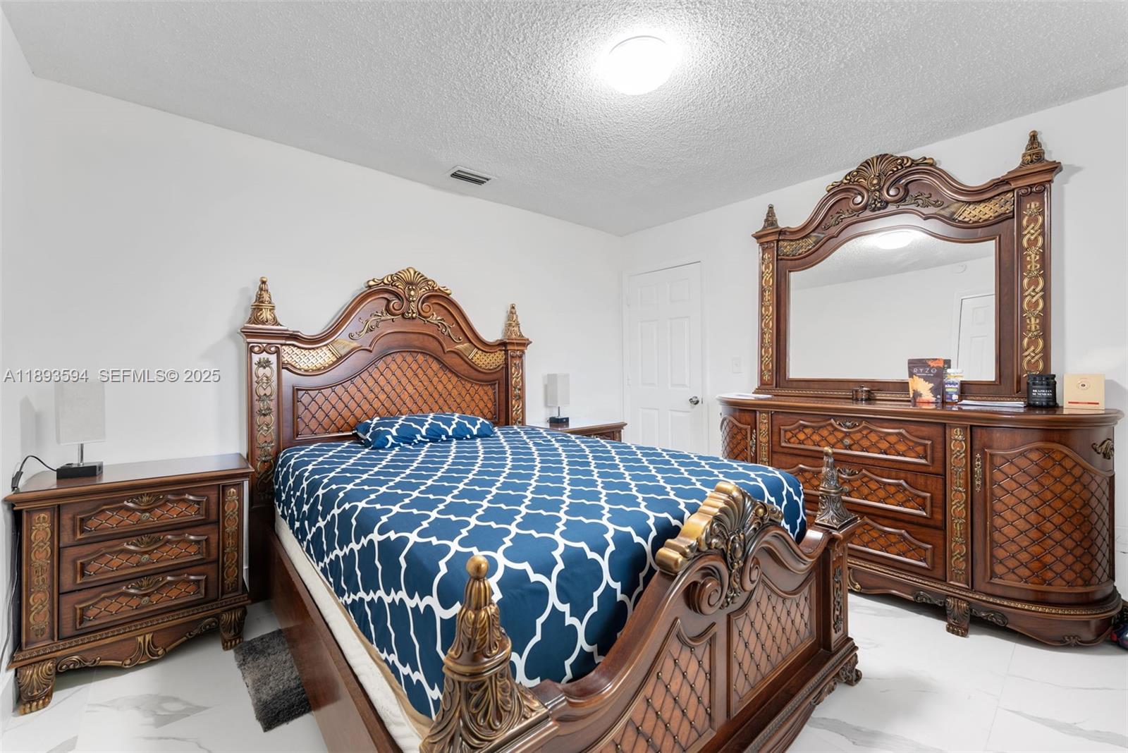 8820 Southwest 27th Street Miami, FL 33165 - Photo 12 of 36 a bedroom with a bed and dresser