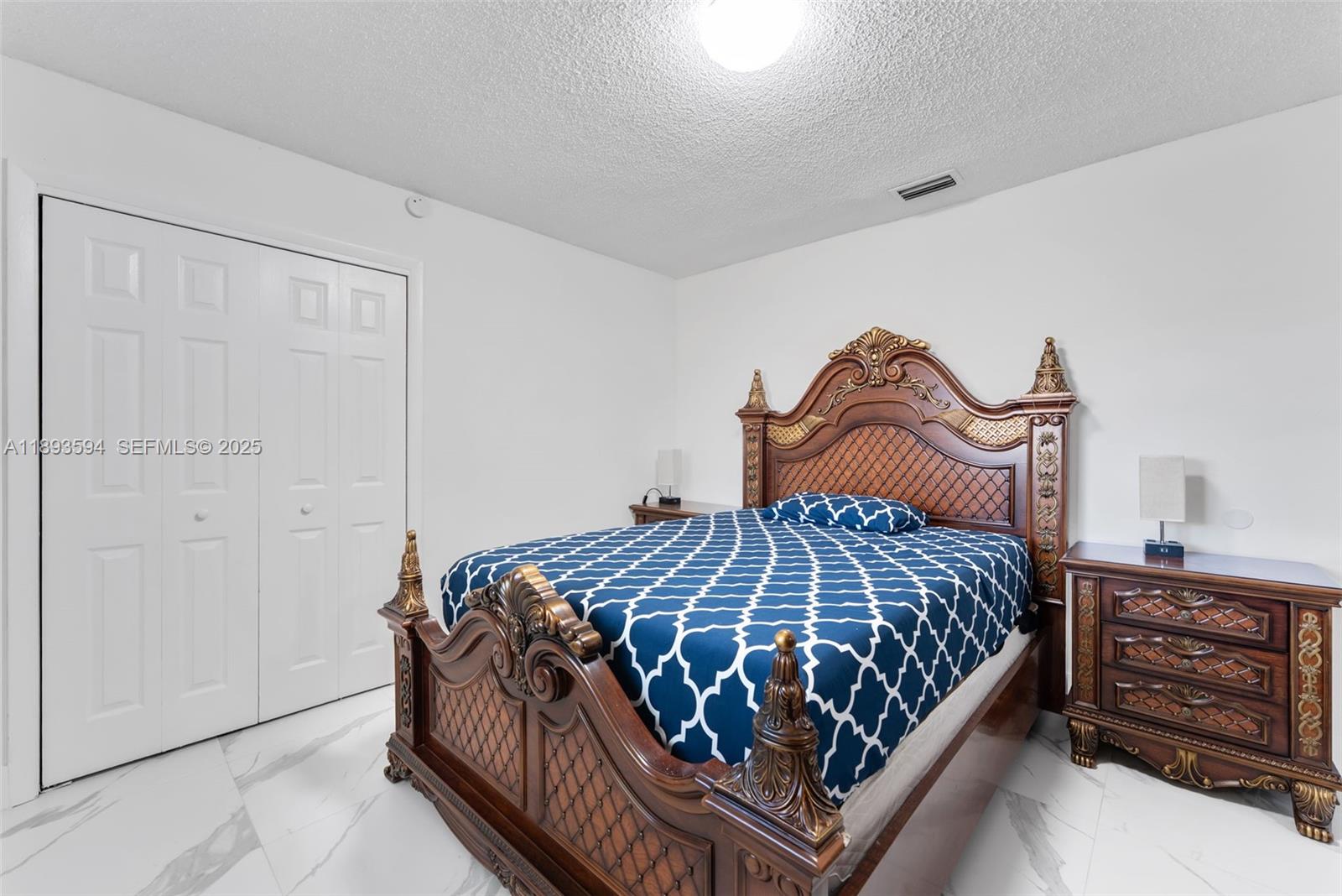 8820 Southwest 27th Street Miami, FL 33165 - Photo 13 of 36 a bedroom with a bed and dresser