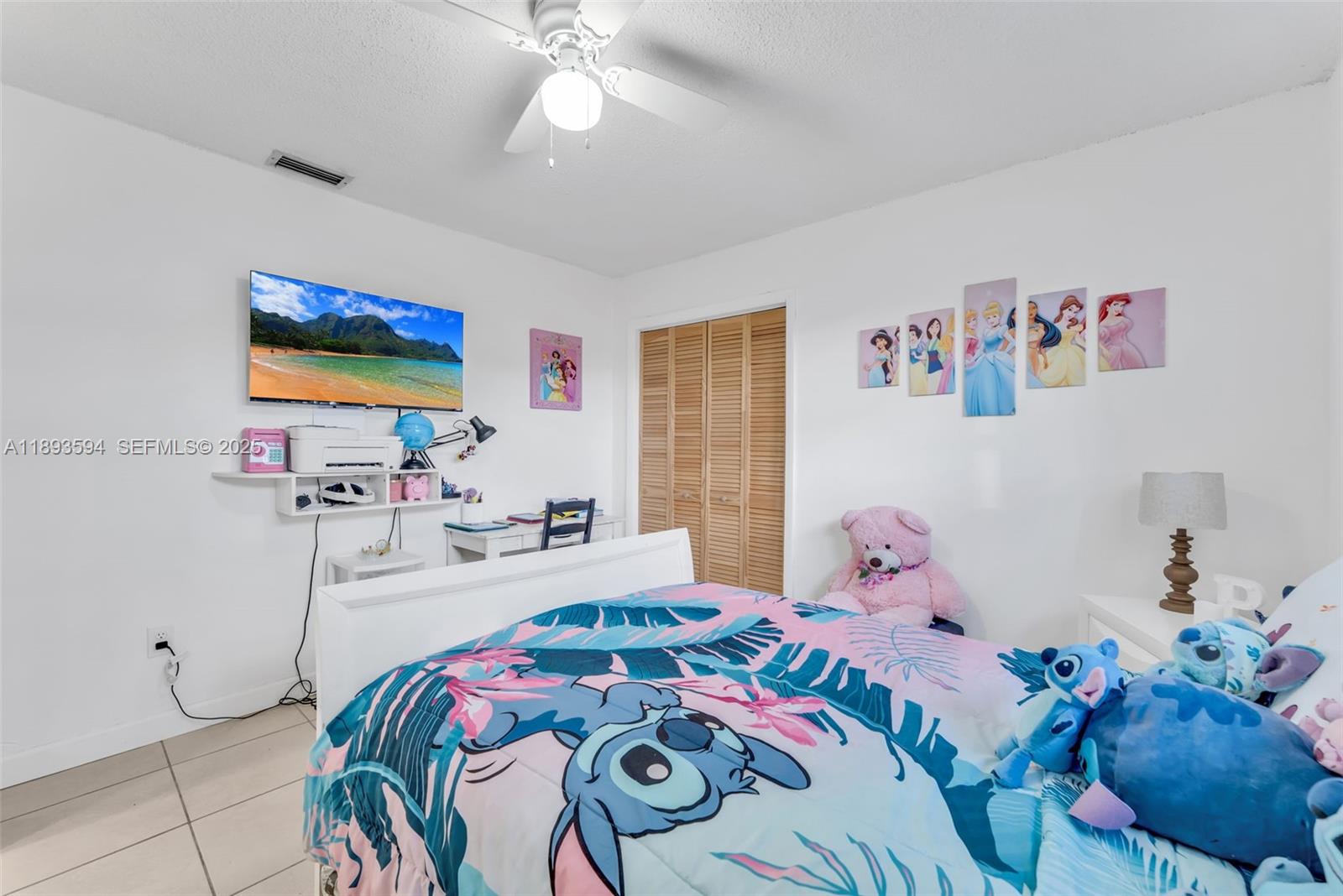 8820 Southwest 27th Street Miami, FL 33165 - Photo 17 of 36 a bedroom with a bed and a chandelier