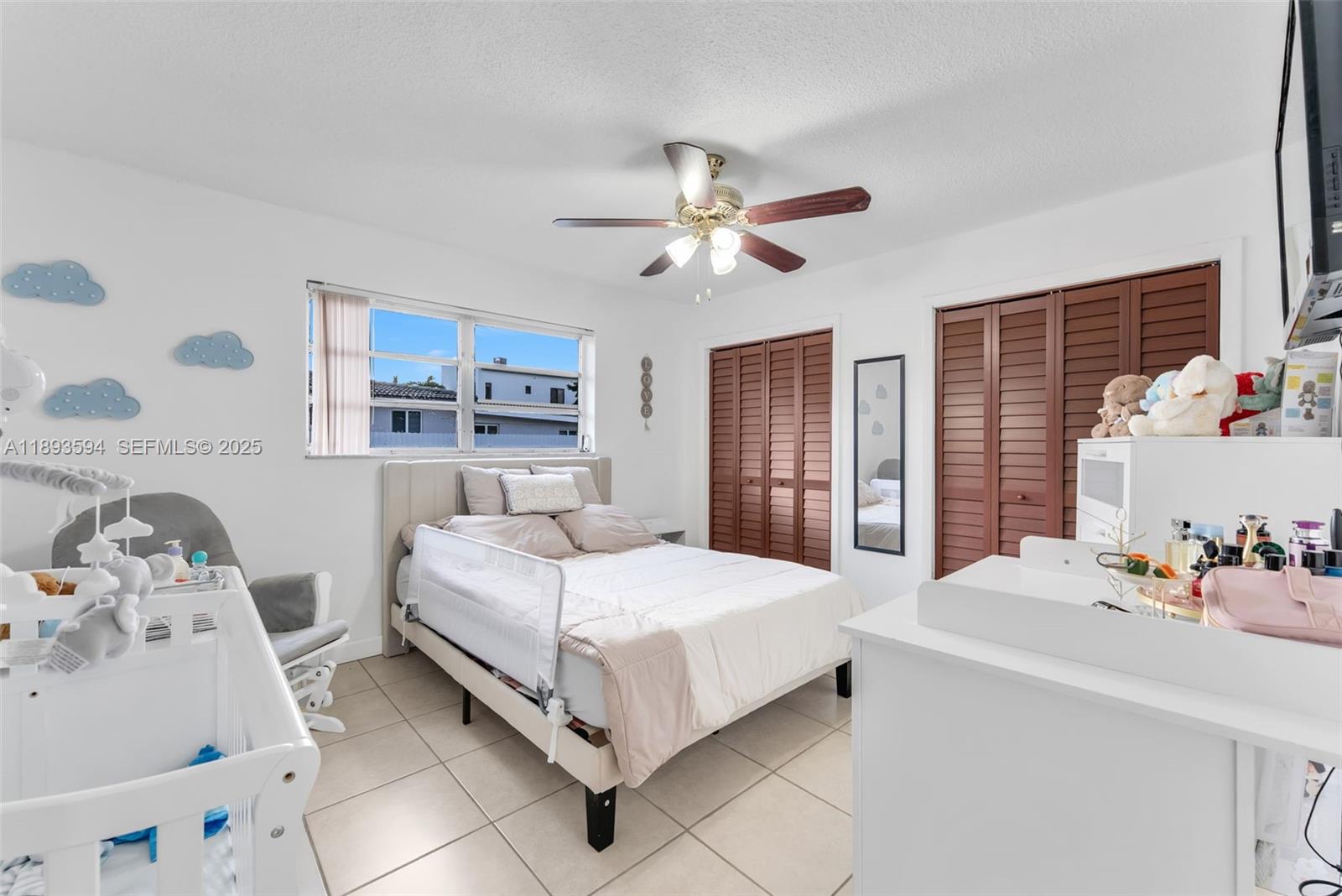 8820 Southwest 27th Street Miami, FL 33165 - Photo 19 of 36 a bedroom with a bed and a chandelier