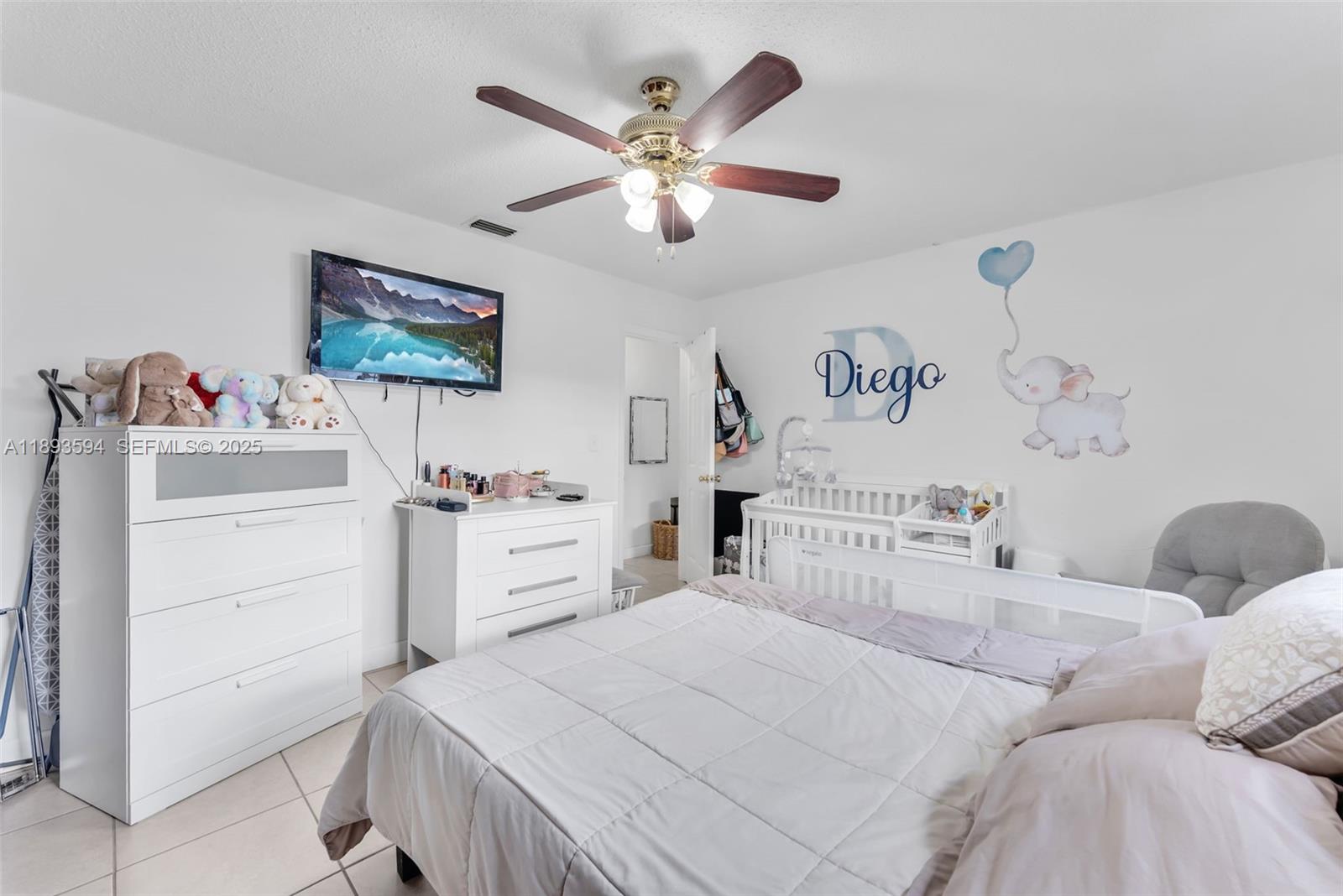 8820 Southwest 27th Street Miami, FL 33165 - Photo 20 of 36 a bedroom with a bed and a chandelier