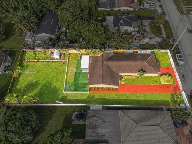an aerial view of residential houses with outdoor space and street view
