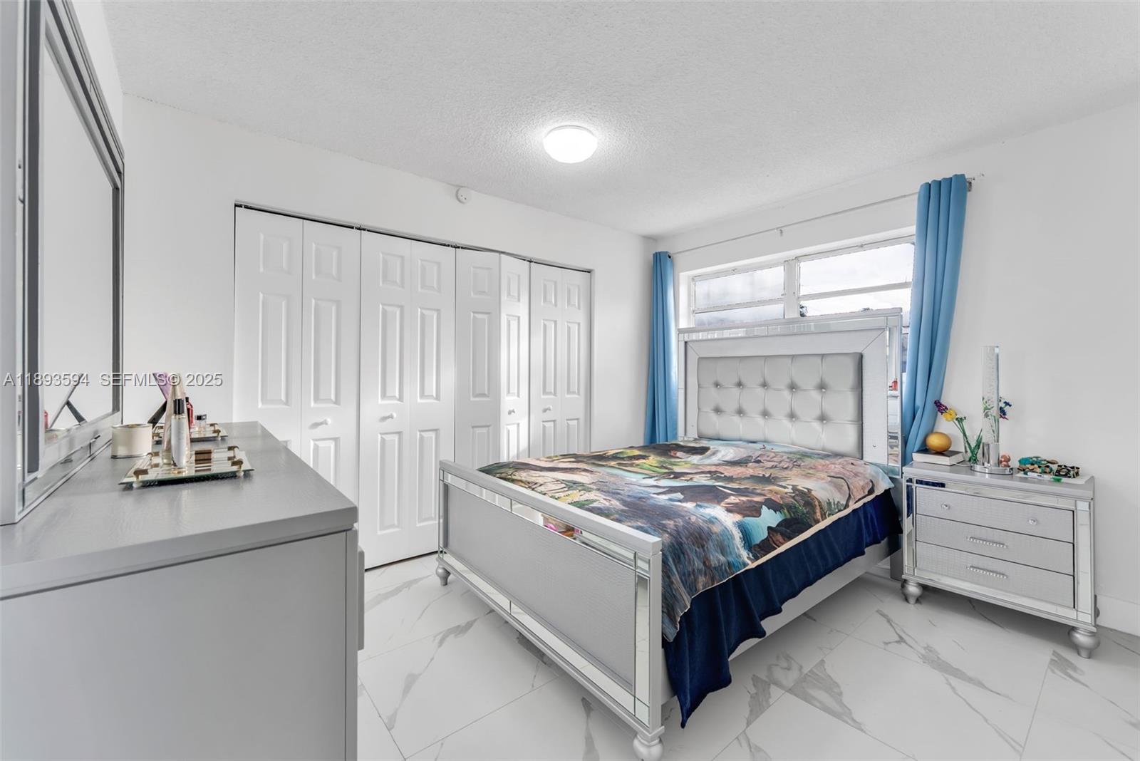 8820 Southwest 27th Street Miami, FL 33165 - Photo 24 of 36 a bedroom with a bed and a dresser