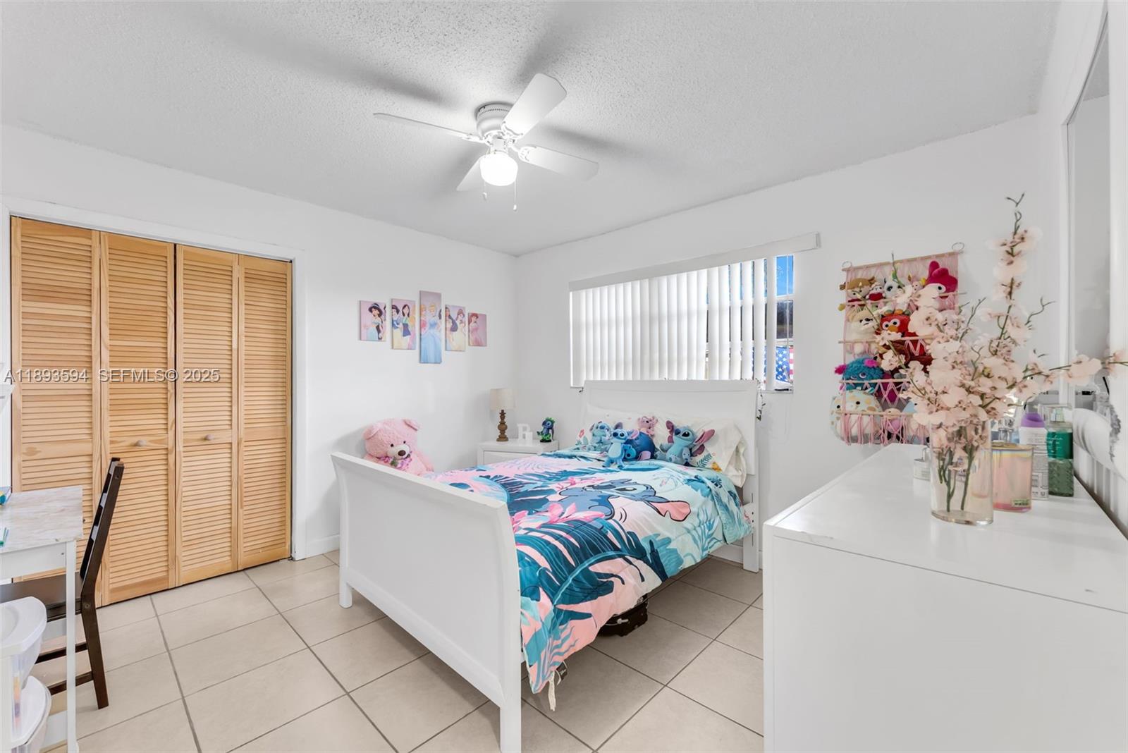 8820 Southwest 27th Street Miami, FL 33165 - Photo 25 of 36 a bedroom with a bed and a chandelier