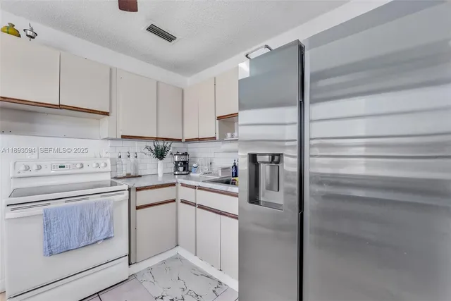 a kitchen with a sink stainless steel appliances and cabinets