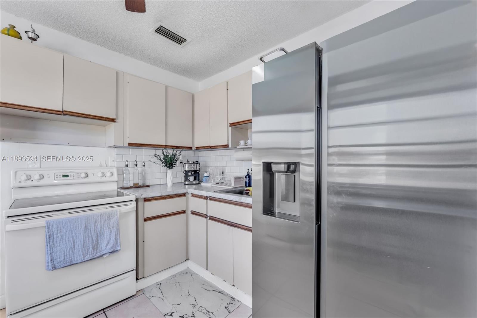 8820 Southwest 27th Street Miami, FL 33165 - Photo 27 of 36 a kitchen with a sink stainless steel appliances and cabinets