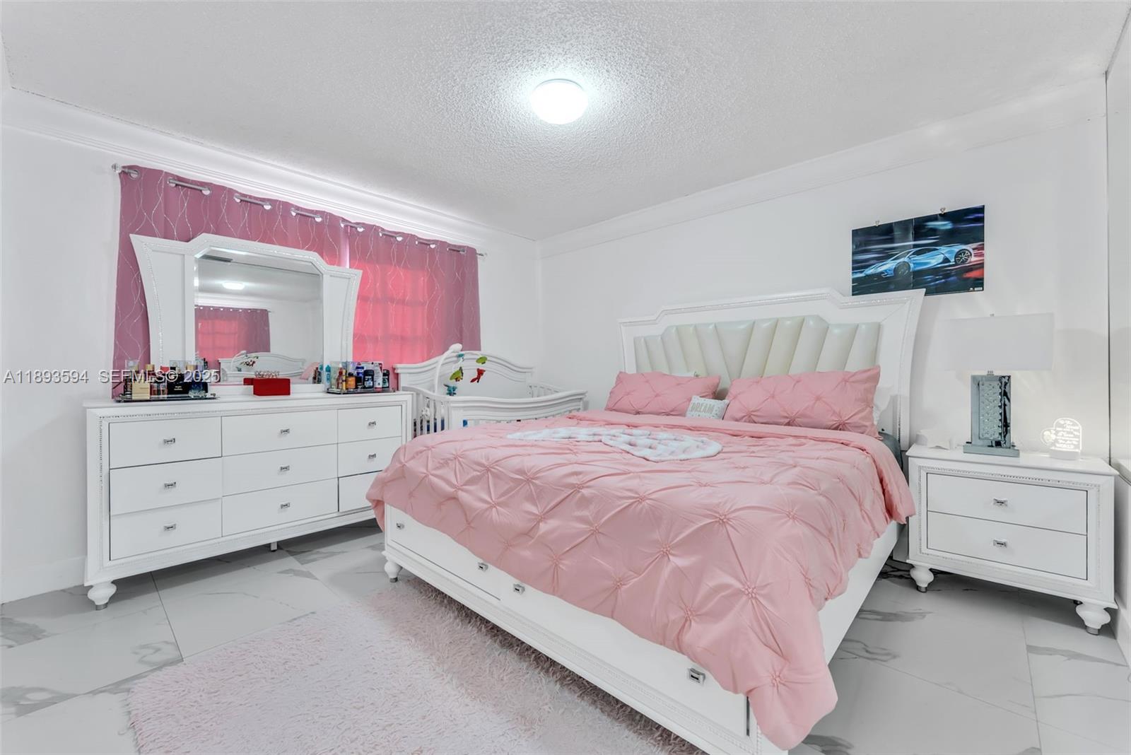 8820 Southwest 27th Street Miami, FL 33165 - Photo 29 of 36 a bedroom with a bed and a dresser