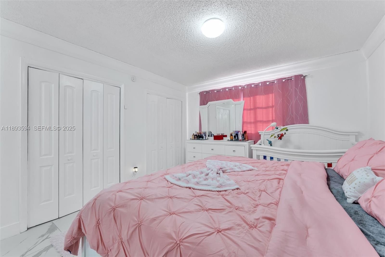 8820 Southwest 27th Street Miami, FL 33165 - Photo 30 of 36 a bedroom with a bed and a dresser