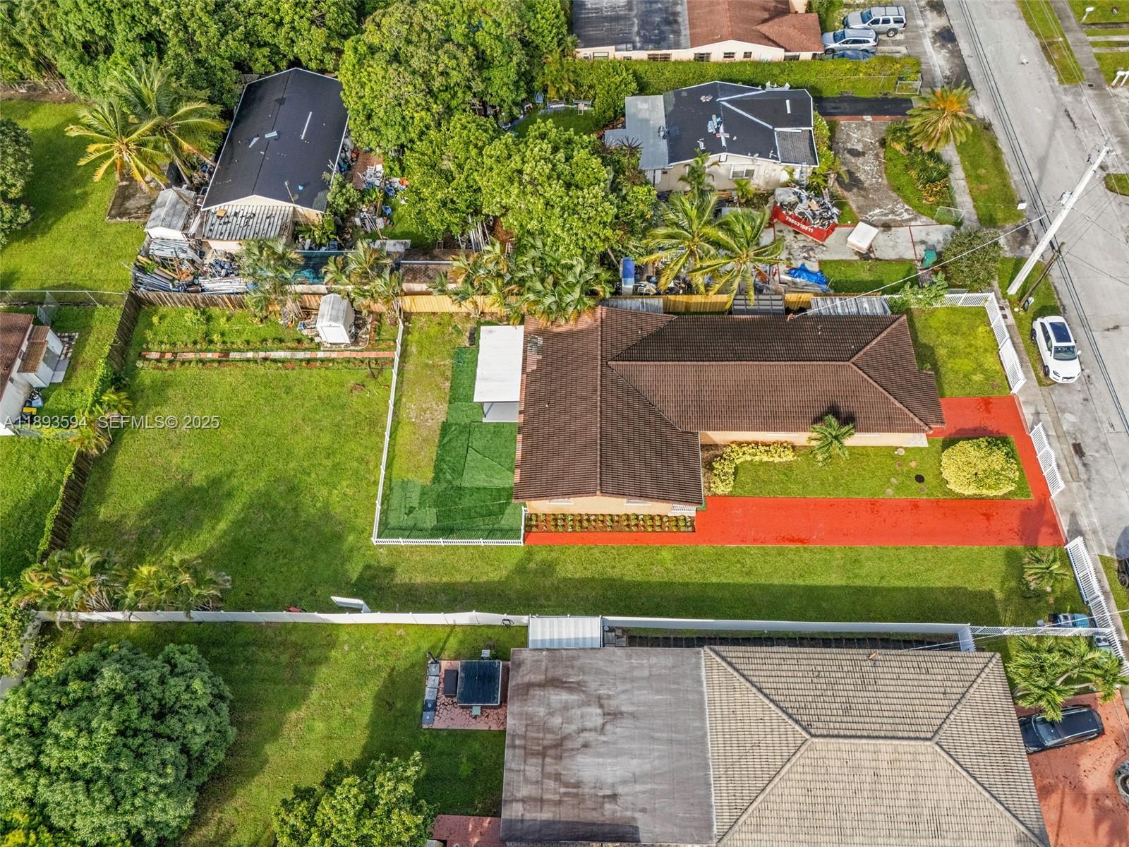 8820 Southwest 27th Street Miami, FL 33165 - Photo 3 of 36 an aerial view of a house with a yard and a large pool