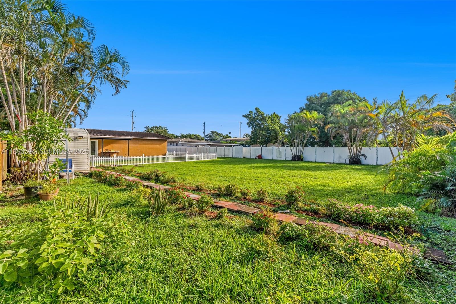 8820 Southwest 27th Street Miami, FL 33165 - Photo 33 of 36 a view of yard with swimming pool and outdoor seating