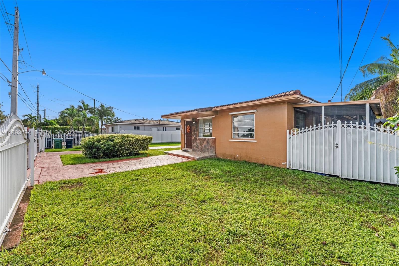 8820 Southwest 27th Street Miami, FL 33165 - Photo 35 of 36 a view of a backyard with potted plants and wooden fence