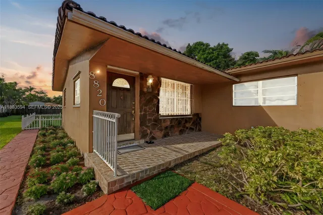 a front view of a house with garden