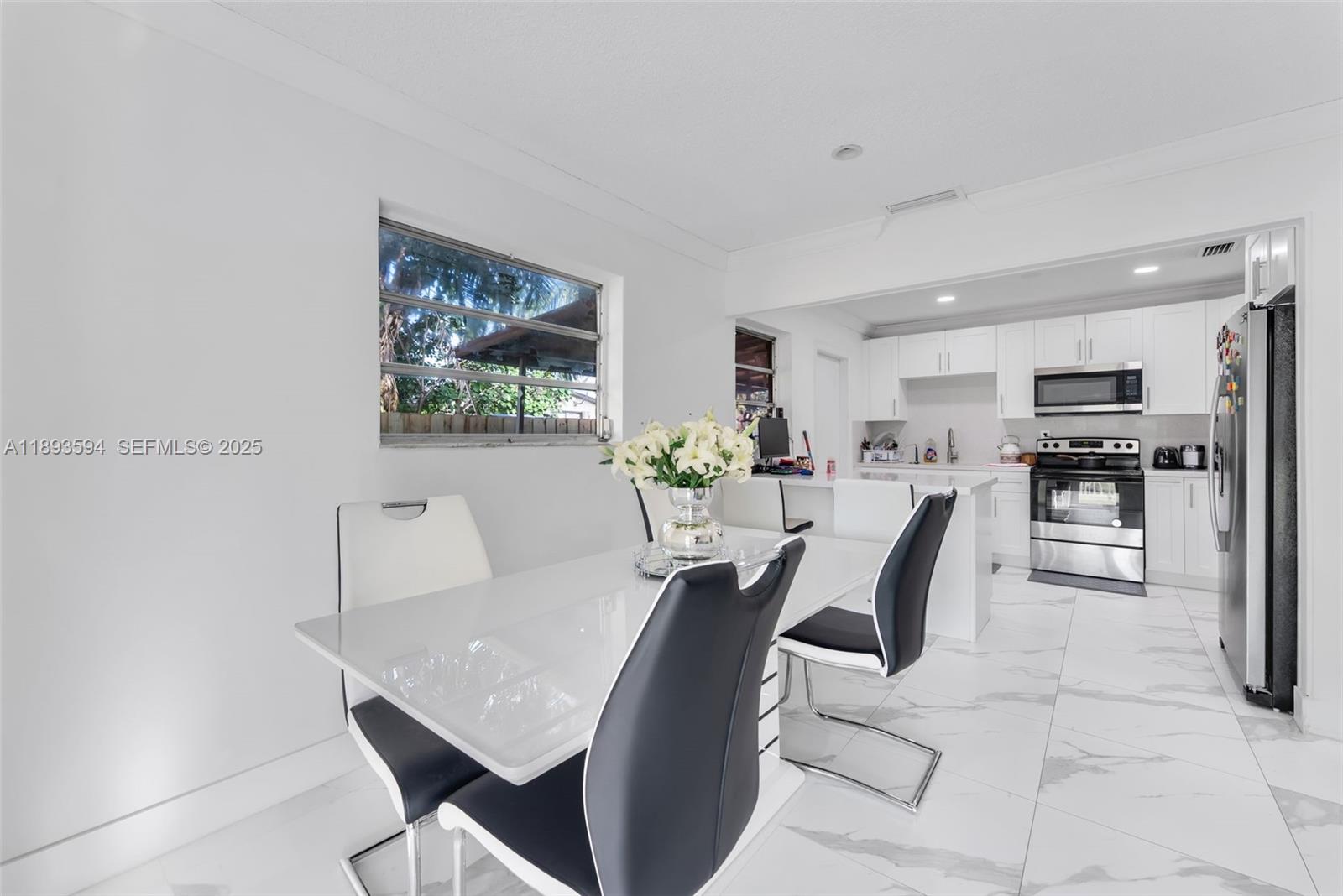 8820 Southwest 27th Street Miami, FL 33165 - Photo 7 of 36 a view of a dining room with furniture