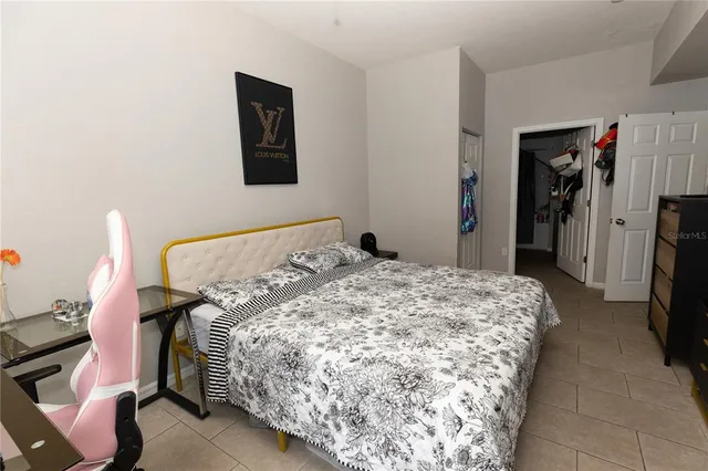 a bedroom with a bed and a mirror