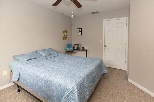 a bedroom with a bed and a television