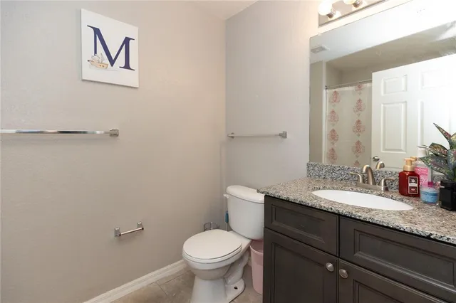 a bedroom with a bed desk and a window