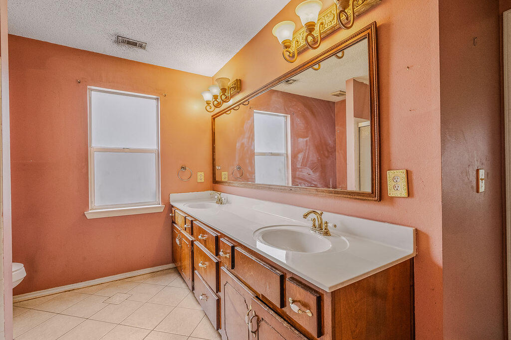 53 4th Street Shalimar, FL 32579 - Photo 26 of 47 a bathroom with a sink and a mirror