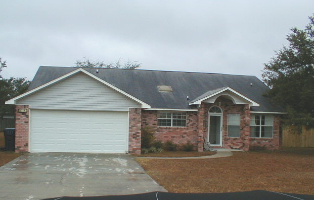2715 Baylen Court Navarre, FL 32566 - Photo 1 of 1 front view of house with a yard