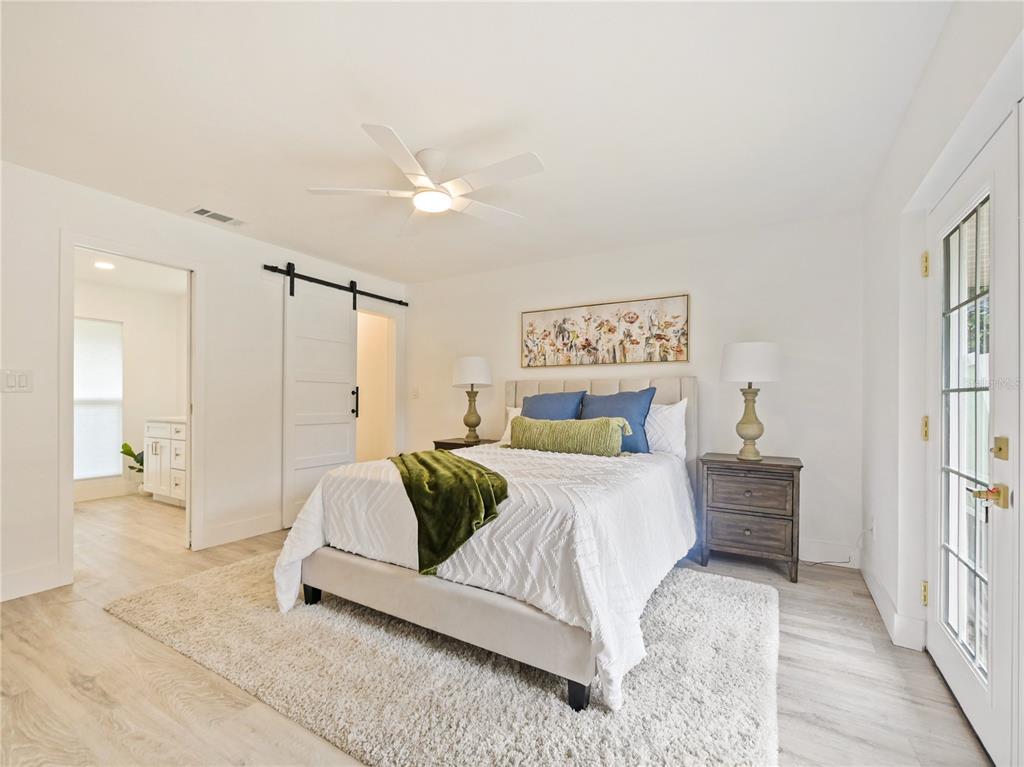 2466 Fieldingwood Road Maitland, FL 32751 - Photo 11 of 29 a bedroom with a bed and a chandelier