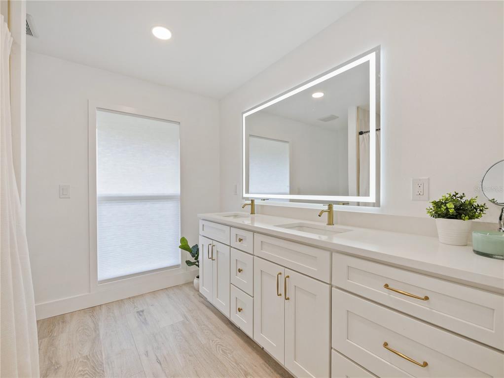 2466 Fieldingwood Road Maitland, FL 32751 - Photo 13 of 29 a bathroom with a double vanity sink and a mirror