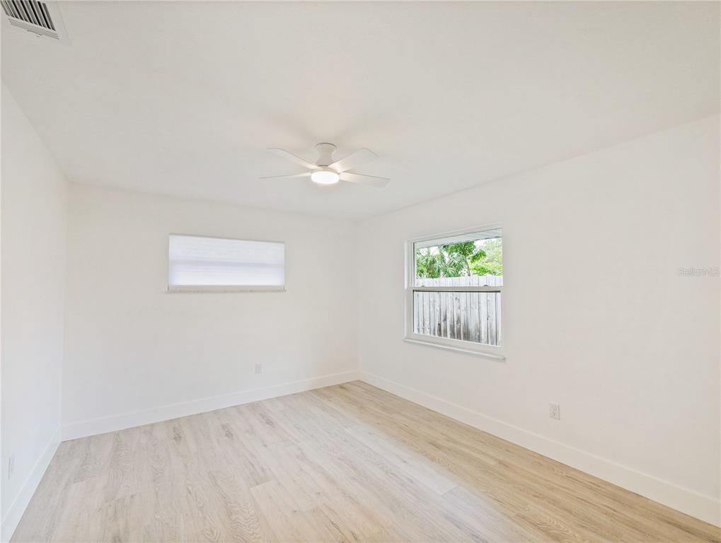 2466 Fieldingwood Road Maitland, FL 32751 - Photo 17 of 29 an empty room with wooden floor and window