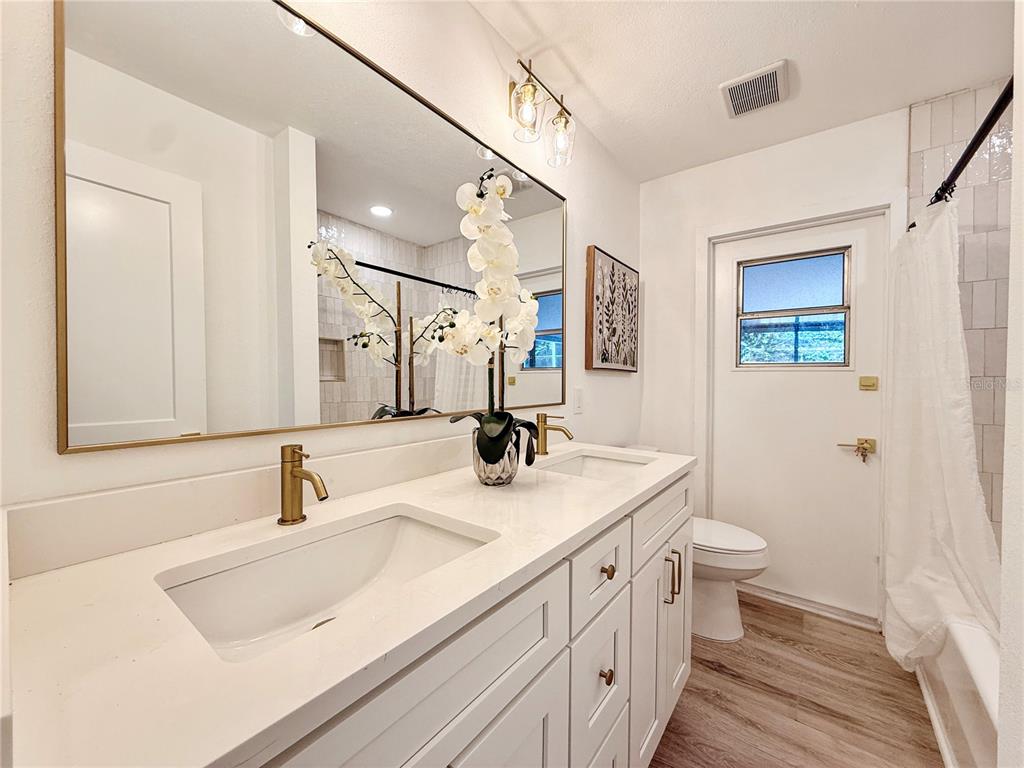 2466 Fieldingwood Road Maitland, FL 32751 - Photo 21 of 29 a bathroom with a sink a toilet and a mirror