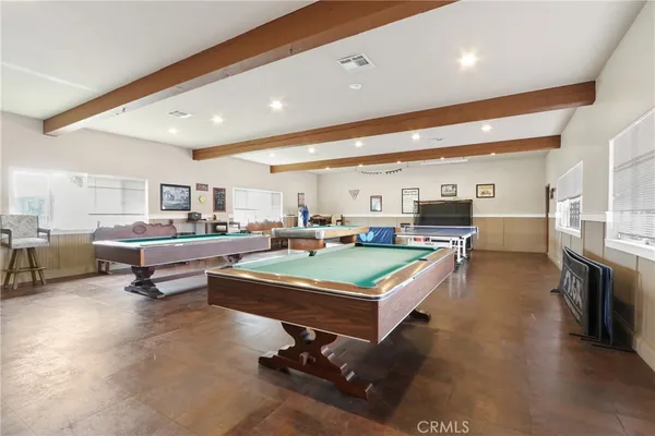 a living room with lots of furniture and view of kitchen