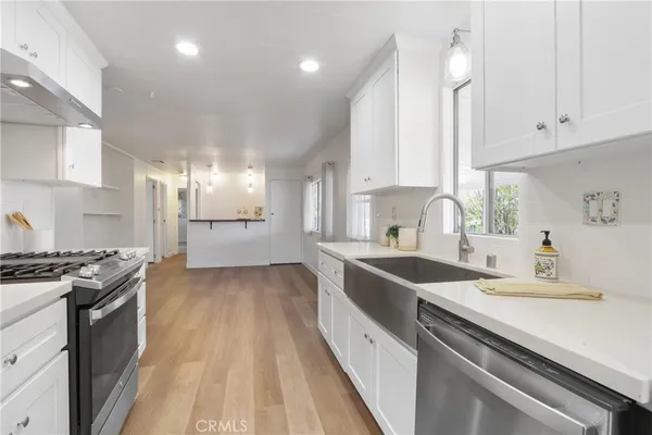 a kitchen with a sink stove and cabinets