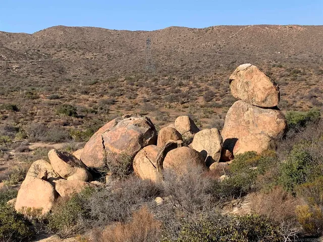a view of a stone house with a yard