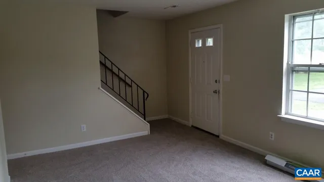 a view of an entryway with wooden floor and staircase