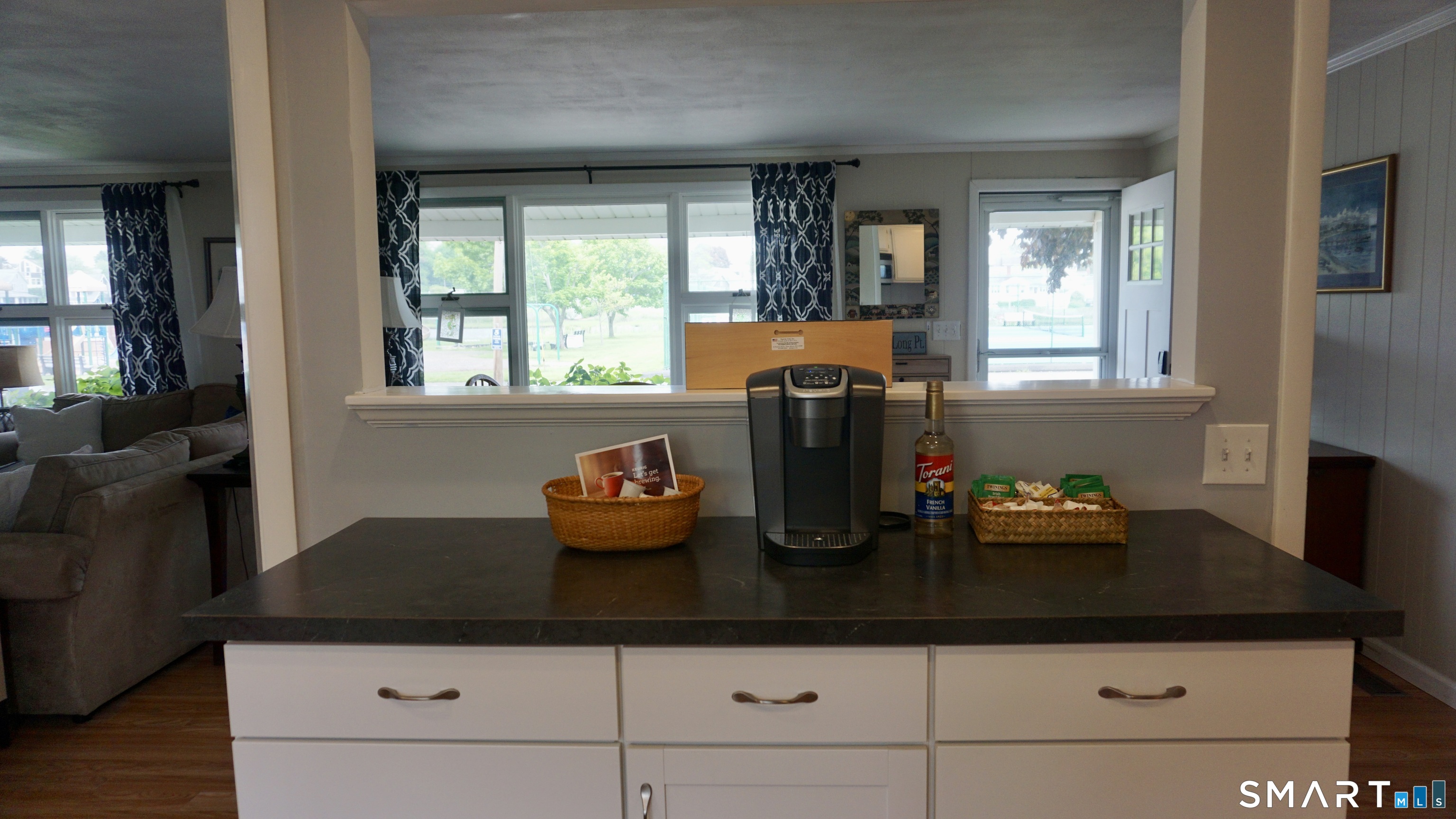13 Pacific Street Groton, CT 06340 - Photo 6 of 31 a kitchen with granite countertop a sink and a stove with wooden floor