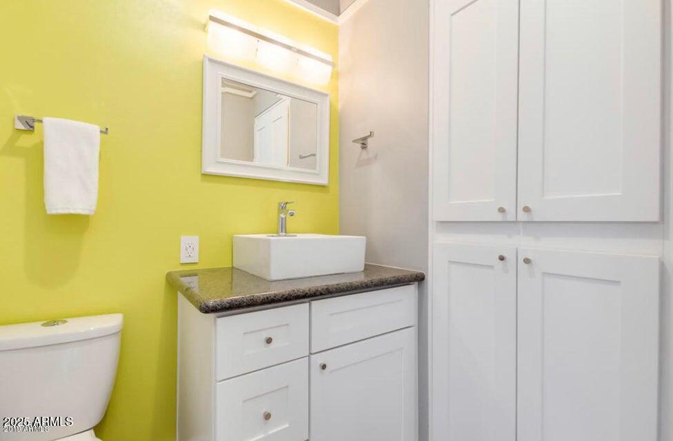 4750 North Central Avenue, Unit L8 Phoenix, AZ 85012 - Photo 11 of 55 a bathroom with a granite countertop sink and a mirror